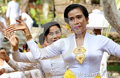 Hindu celebration at Bali Indonesia, religious ceremony with yellow and white colors, woman dancing. Editorial Stock Photo