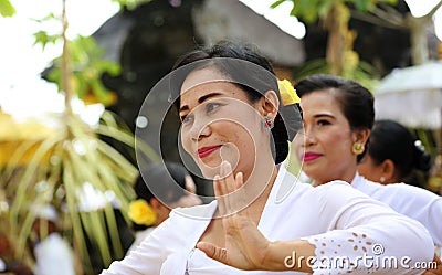 Hindu celebration at Bali Indonesia, religious ceremony with yellow and white colors, woman dancing. Editorial Stock Photo