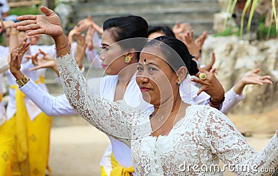 Hindu celebration at Bali Indonesia, religious ceremony with yellow and white colors, woman dancing. Editorial Stock Photo