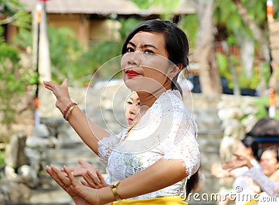 Hindu celebration at Bali Indonesia, religious ceremony with yellow and white colors, woman dancing. Editorial Stock Photo