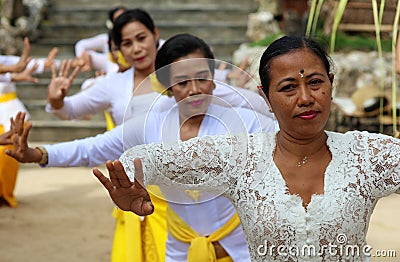 Hindu celebration at Bali Indonesia, religious ceremony with yellow and white colors, woman dancing. Editorial Stock Photo