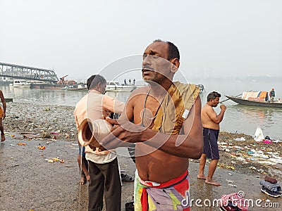 A hindu devotees performing surjo namaskar after the ganges bath as a ritual. Editorial Stock Photo