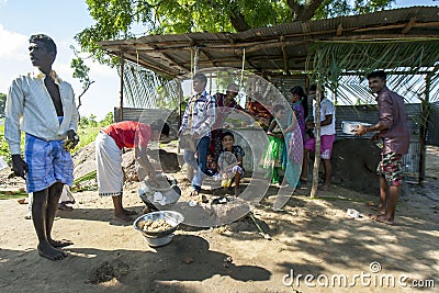 Hindu followers cook rice in front of a temporary roadside temple near Pottuvil in Sri Lanka. Editorial Stock Photo