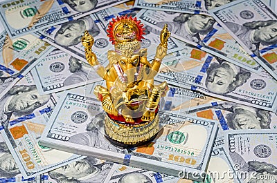 Hindu Ganesha god of wisdom with money american dollars bills Stock Photo