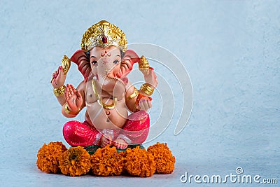 Hindu God Ganesha. Ganesha Idol on blue background Stock Photo