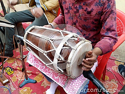 Hindu man play drums,a musical instrument in a religious gathering Editorial Stock Photo