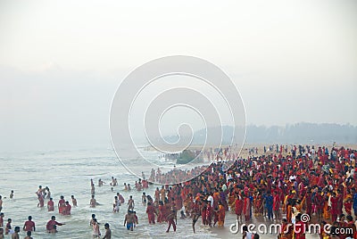 Hindu people, group in red at the sea in Tamil Nadu, India Editorial Stock Photo