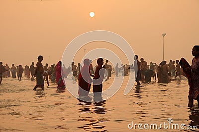 Hindu pilgrims take holy dip in Ganges Editorial Stock Photo