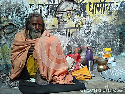 Hindu piligrim sadhu in orange clothes on the streets in India Editorial Stock Photo