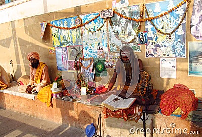 Hindu piligrim sadhu praying on the street in India Editorial Stock Photo