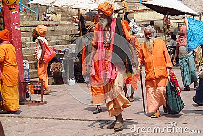 Hindu piligrims sadhu in orange clothes on the streets in India Editorial Stock Photo