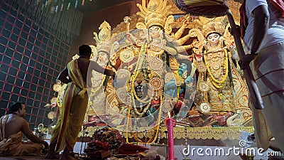 Hindu Priest worshipping Goddess Durga with chamor, fly whisk fan Editorial Stock Photo