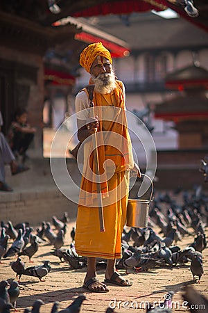 Hindu sadhu man and doves on Durbar square in Kathmandu Editorial Stock Photo