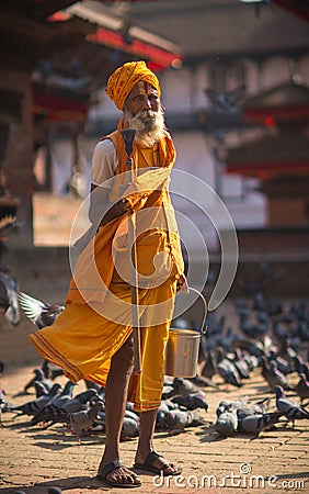 Hindu sadhu man and doves on Durbar square in Kathmandu Editorial Stock Photo