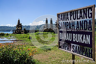 Hindu temple ruins of Pura Hulun Danu with caution board sign do not litter at the Tamblingan lake, Bali, Indonesia Stock Photo