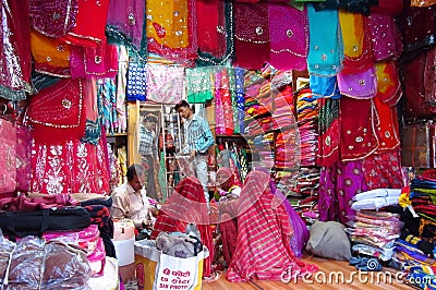 Hindu women dressed in colorful sari in Indian street market Editorial Stock Photo