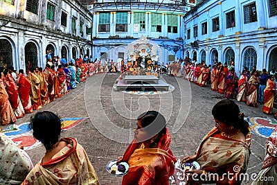 Hindu women walking around Durga Devi statue Editorial Stock Photo