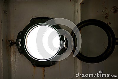 Hinged round window, storm cover on ship looking outside into Mediterranean sea. Porthole view through window on ship. Stock Photo