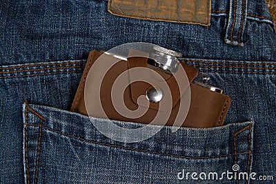 Hip flask in jeans pocket Stock Photo