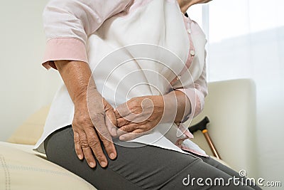 Hip pain of senior woman at home, healthcare problem of senior concept Stock Photo