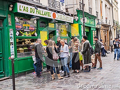 Hip Parisians line up at falafel shop in the Marais, Paris, Fran Editorial Stock Photo