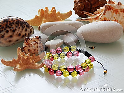 Colorful friendship bracelet and pebble Stock Photo