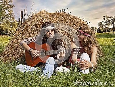 Hippie couple playing guitar Stock Photo