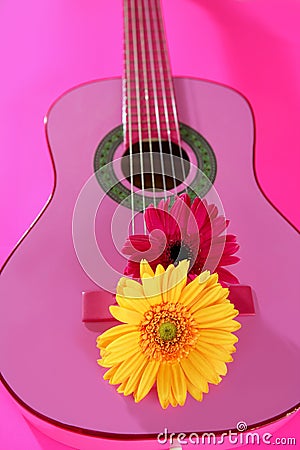 Hippie flower yellow pink gerbera on guitar Stock Photo