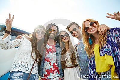 Hippie friends over minivan car showing peace sign Stock Photo