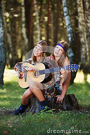 Hippie girls with guitar on nature Stock Photo