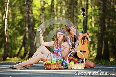 Hippie girls with guitar outdoor Stock Photo