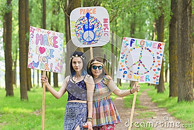 Hippie Girls with Peace and Love Boards Editorial Stock Photo