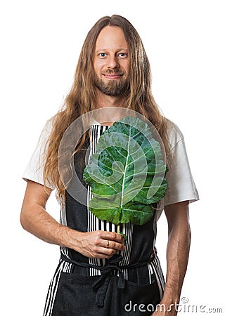 Hippie man holding a kale leaf over his heart Stock Photo