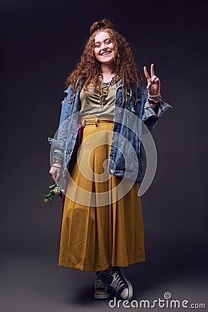 Hippy girl with curly hairstyle in mustard maxiskirt Stock Photo