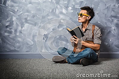 Hipster asian man reading a book, vintage. Stock Photo