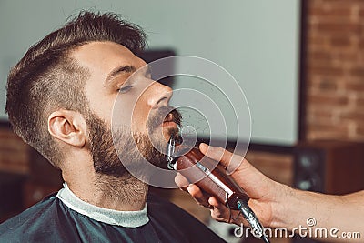 Hipster client visiting barber shop Stock Photo