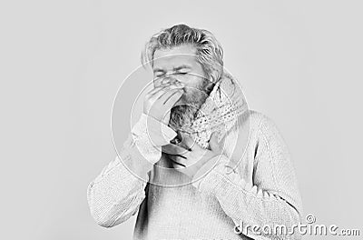 Hipster fever. Immune response. Bearded man sick. Warm scarf around neck. Cold flu fever concept. Body temperature Stock Photo
