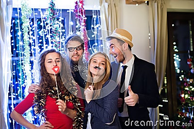 Hipster friends celebrating New Years Eve together, photobooth p Stock Photo