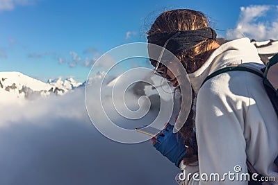 Hipster girl with closeup with backpack and mobile phone in high Stock Photo