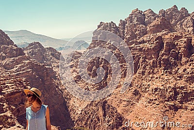 Hipster girl enjoy vacation and journey to Jordan. Gorgeous view from Petra. Negative space for text. Tourism industry. Active lif Stock Photo