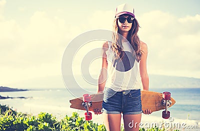 Hipster girl with skate board wearing sunglasses Stock Photo