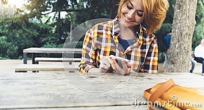 Hipster girl using phone technology internet, blogger person holding mobile smartphone on background sun city, female hands text Stock Photo