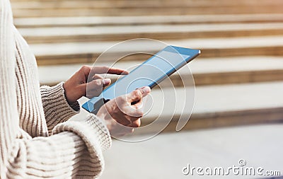 Hipster girl using tablet technology internet, blogger person holding computer on background sun city, female hands texting online Stock Photo