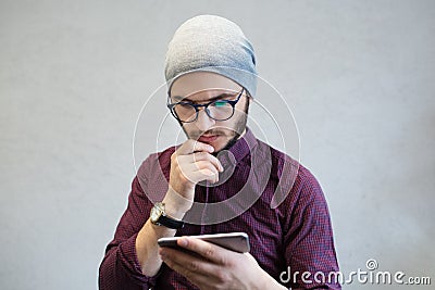 Hipster guy using smarphone on background of white. Stock Photo