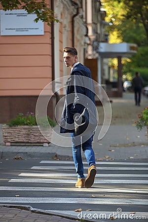 Hipster guy walking down the street, urban style Stock Photo