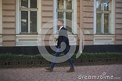 Hipster guy walking down the street, urban style Stock Photo