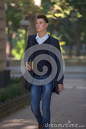 Hipster guy walking down the street, urban style Stock Photo