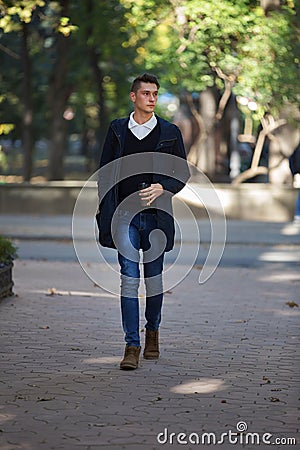 Hipster guy walking down the street, urban style Stock Photo