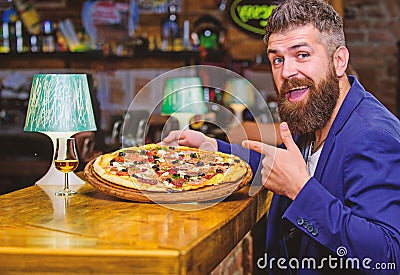 Hipster hungry eat italian pizza. Pizza favorite restaurant food. Fresh hot pizza for dinner. Hipster client sit at bar Stock Photo