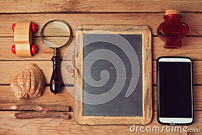 Hipster lifestyle. Vintage and modern objects collection over wooden table. Mock up for your logo design display. View from top. Stock Photo